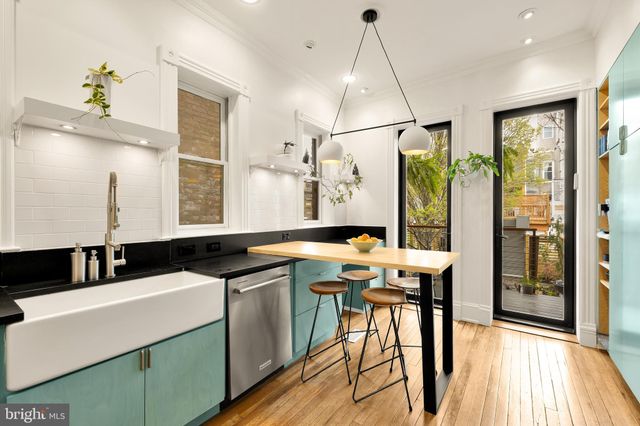 a kitchen with stainless steel appliances a refrigerator microwave and stove top oven