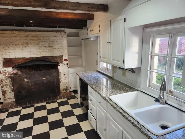 a kitchen with granite countertop stainless steel appliances a sink and a counter space
