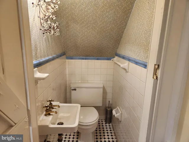 a bathroom with a granite countertop shower a toilet and a sink