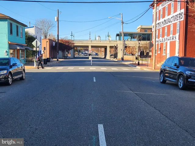 a view of front door with wooden floor and stairs