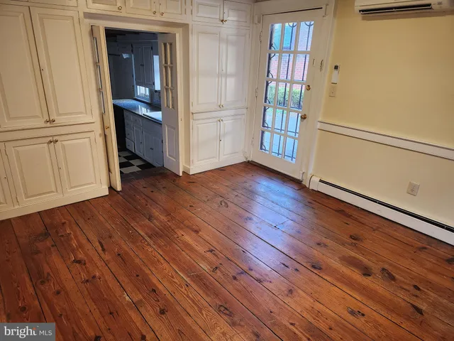 a view of an entryway with wooden floor
