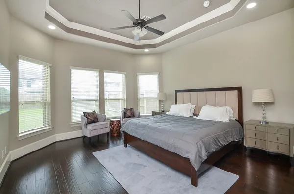 a bedroom with a large bed and a large window