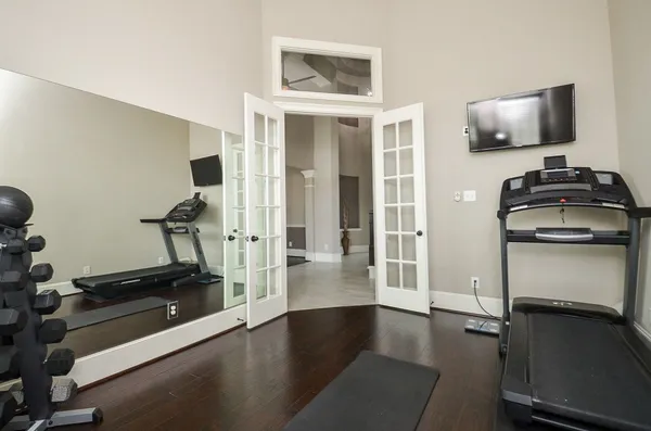 a view of a livingroom with wooden floor and a flat screen tv