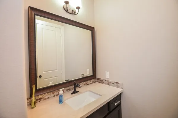 a bathroom with a sink and a mirror
