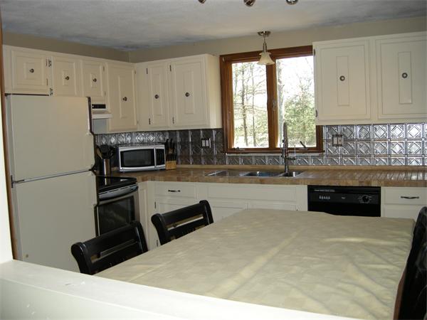 8 Kilsyth Road Easton, MA 02375 - Photo 3 of 7 a kitchen with granite countertop a refrigerator a stove a sink a counter space and cabinets