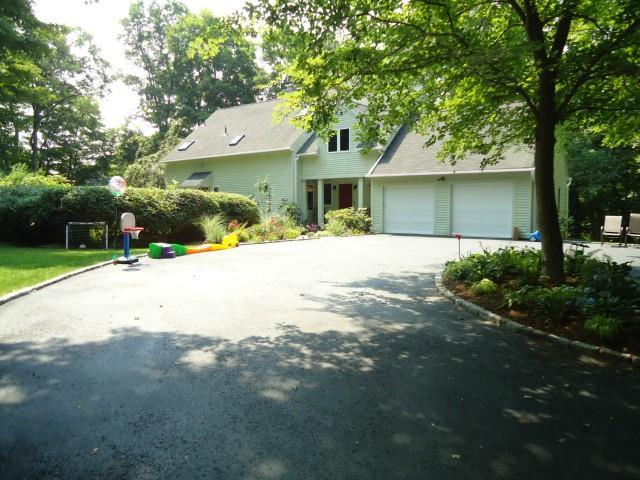 82 Georgetown Road Weston, CT 06883 - Photo 1 of 1 a front view of a house with a yard and garage