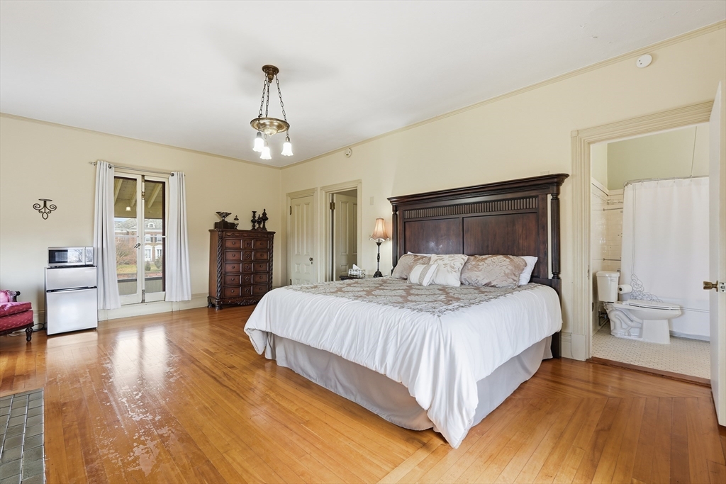270 Maple Street Springfield, MA 01105 - Photo 26 of 42 a bedroom with a large bed and wooden floor