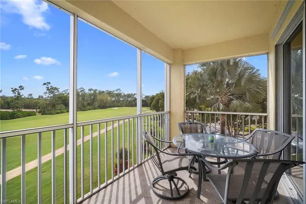 a view of a balcony with chair and wooden floor