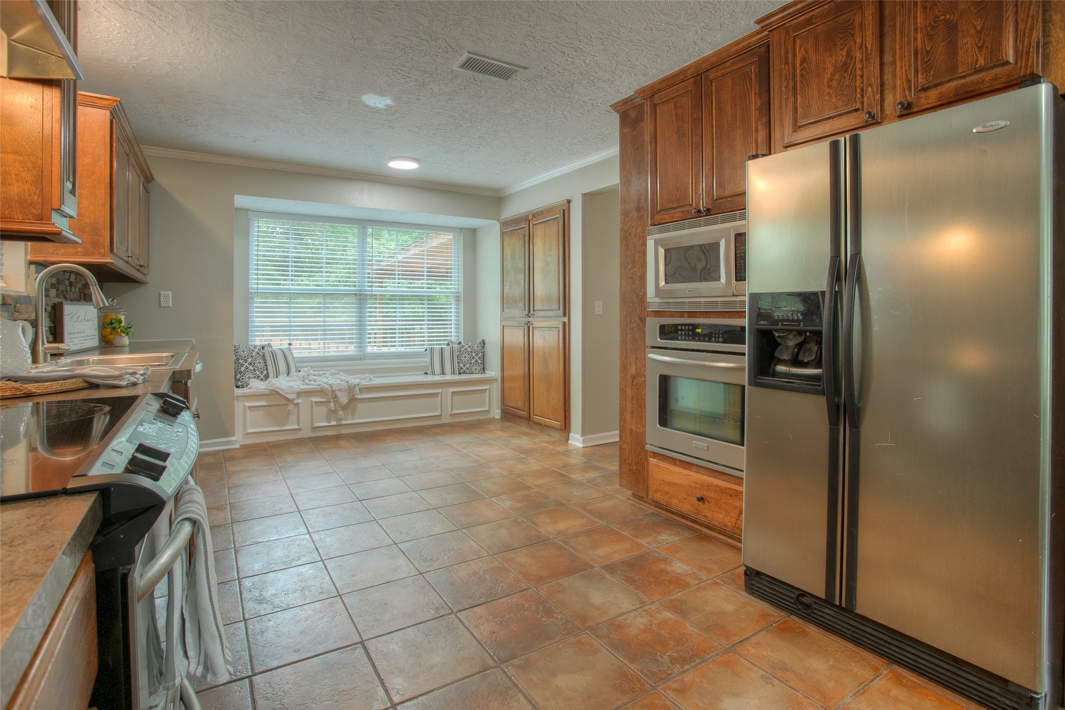 6016 Teas Nursery Road Conroe, TX 77304 - Photo 13 of 50 Stainless steel appliance package includes refrigerator, freestanding electric smooth top range, built-in oven, microwave, and dishwasher.