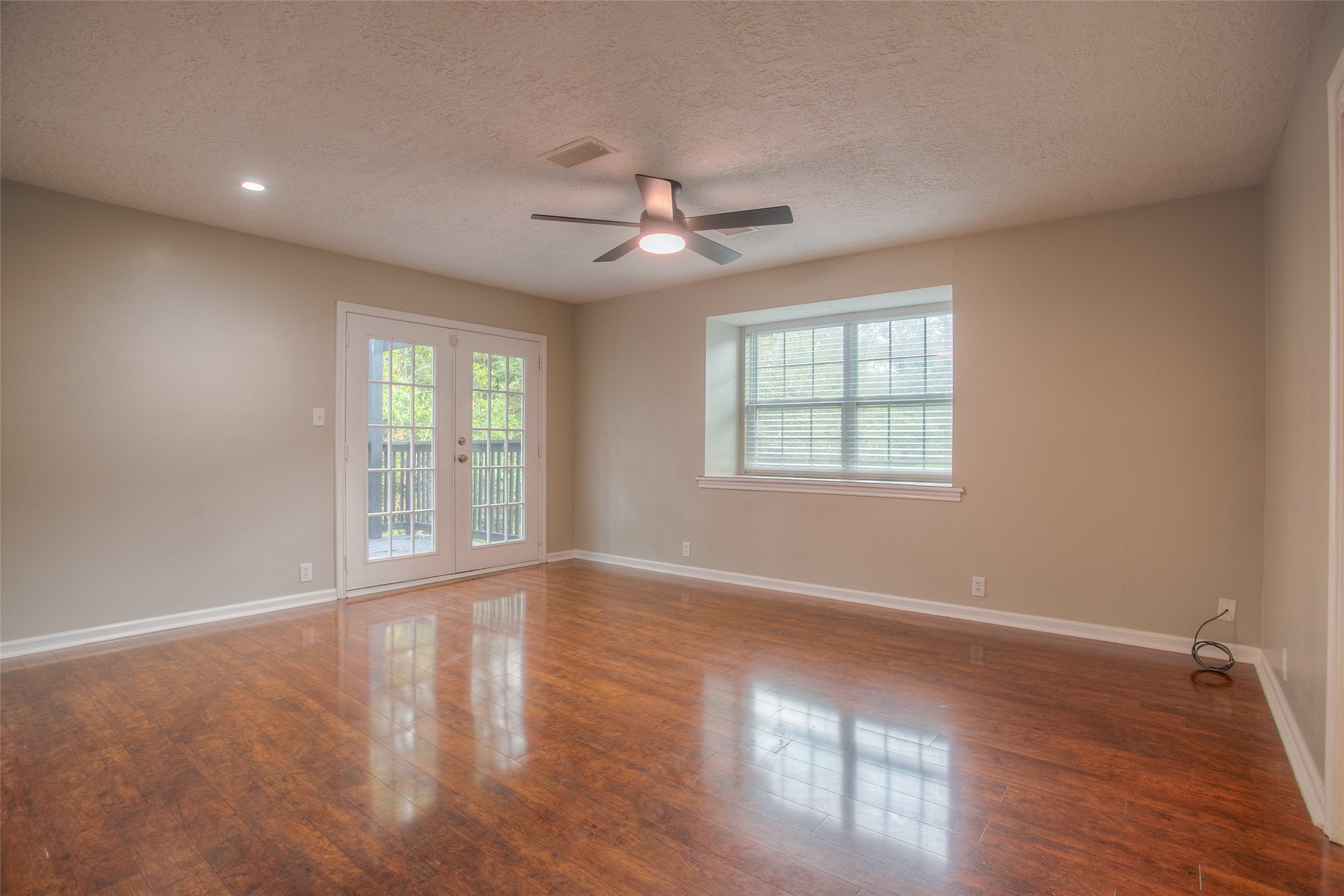 6016 Teas Nursery Road Conroe, TX 77304 - Photo 30 of 50 French doors in the primary bedroom that lead to the relaxing open wood deck.
