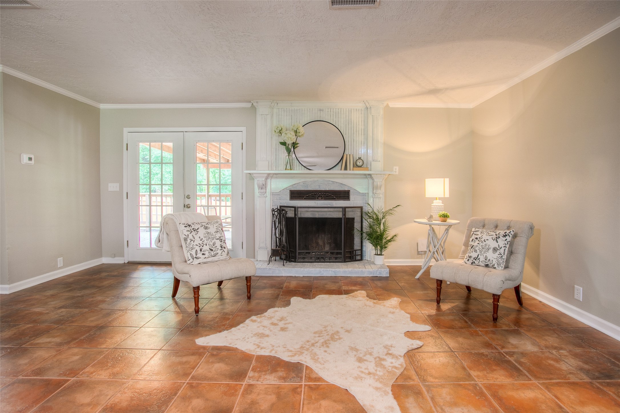 6016 Teas Nursery Road Conroe, TX 77304 - Photo 6 of 50 To the left of the fireplace are French doors that lead to the relaxing covered patio.