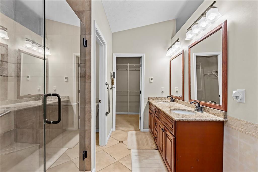 3360 Ennfield Lane Duluth, GA 30096 - Photo 15 of 38 a bathroom with a double vanity sink mirror and shower