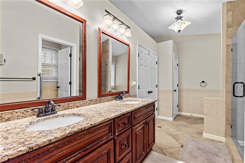 3360 Ennfield Lane Duluth, GA 30096 - Photo 16 of 38 a bathroom with a granite countertop double vanity sink and a mirror