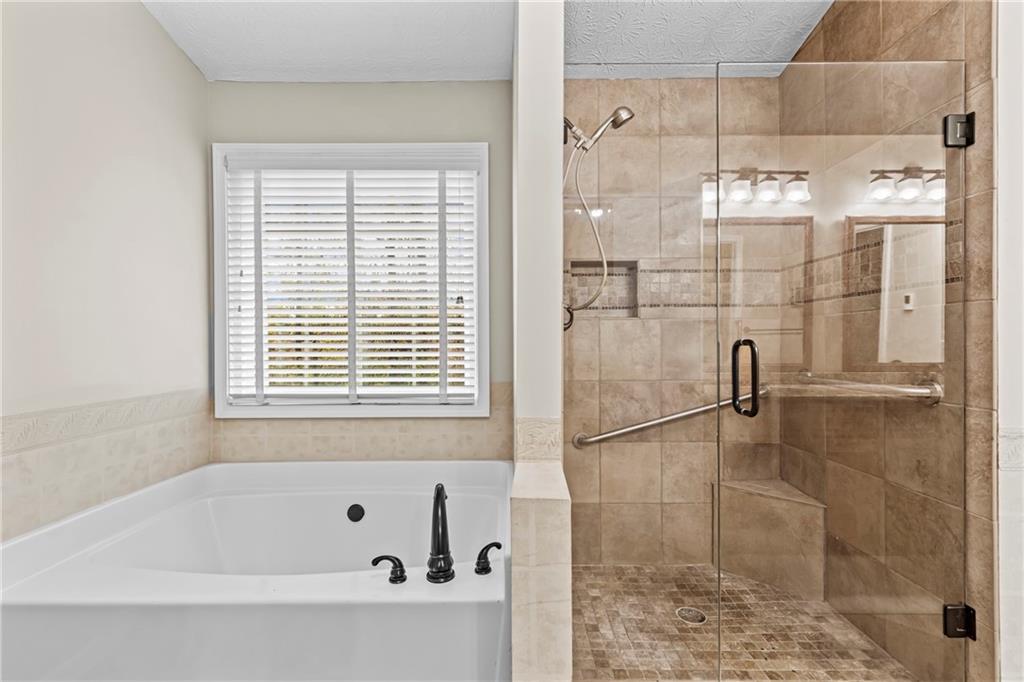 3360 Ennfield Lane Duluth, GA 30096 - Photo 17 of 38 a bathroom with a bathtub and shower