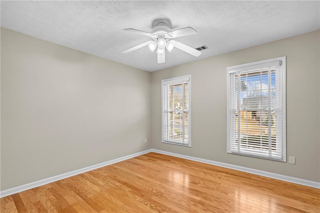 3360 Ennfield Lane Duluth, GA 30096 - Photo 19 of 38 a view of an empty room with wooden floor and a window