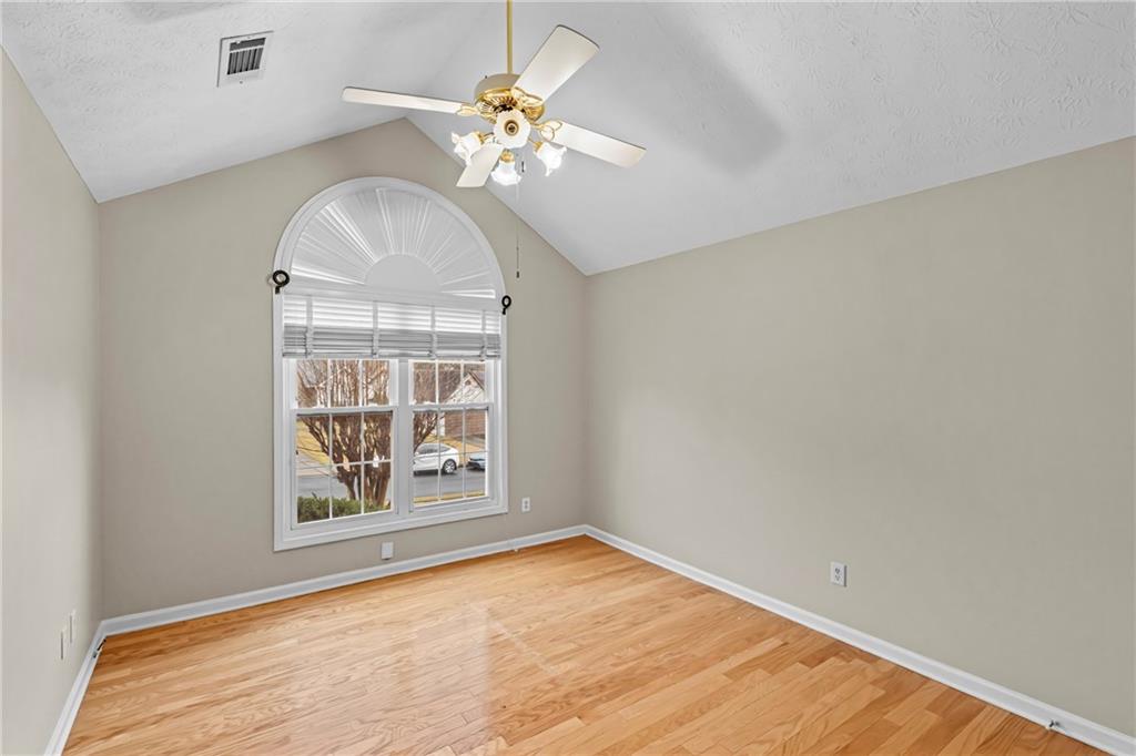 3360 Ennfield Lane Duluth, GA 30096 - Photo 22 of 38 an empty room with windows and chandelier fan