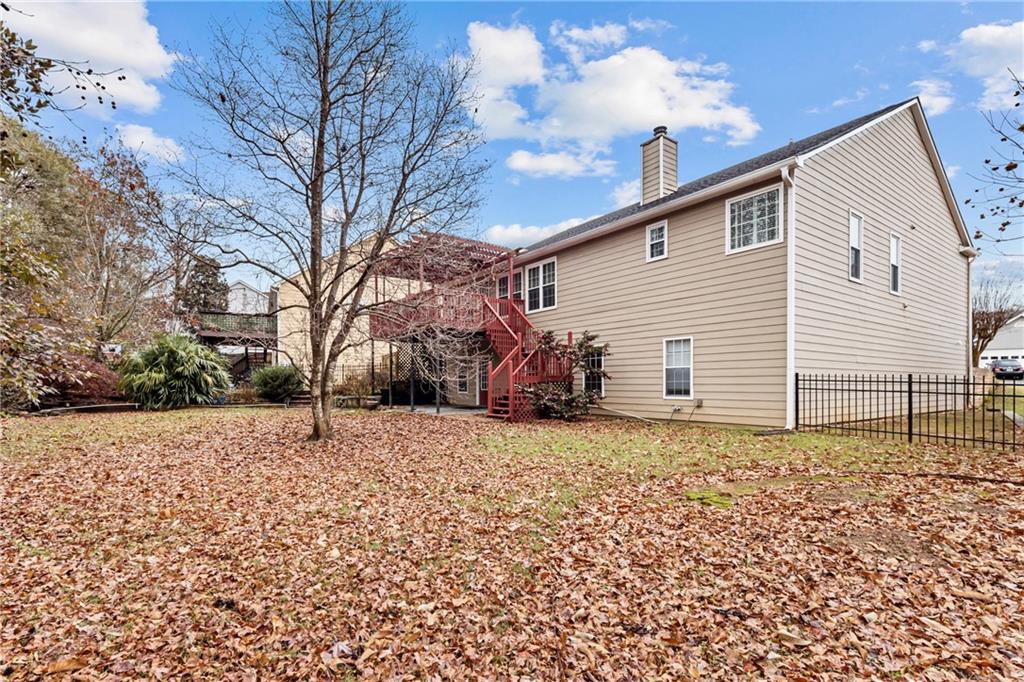 3360 Ennfield Lane Duluth, GA 30096 - Photo 31 of 38 a backyard of a house with large trees