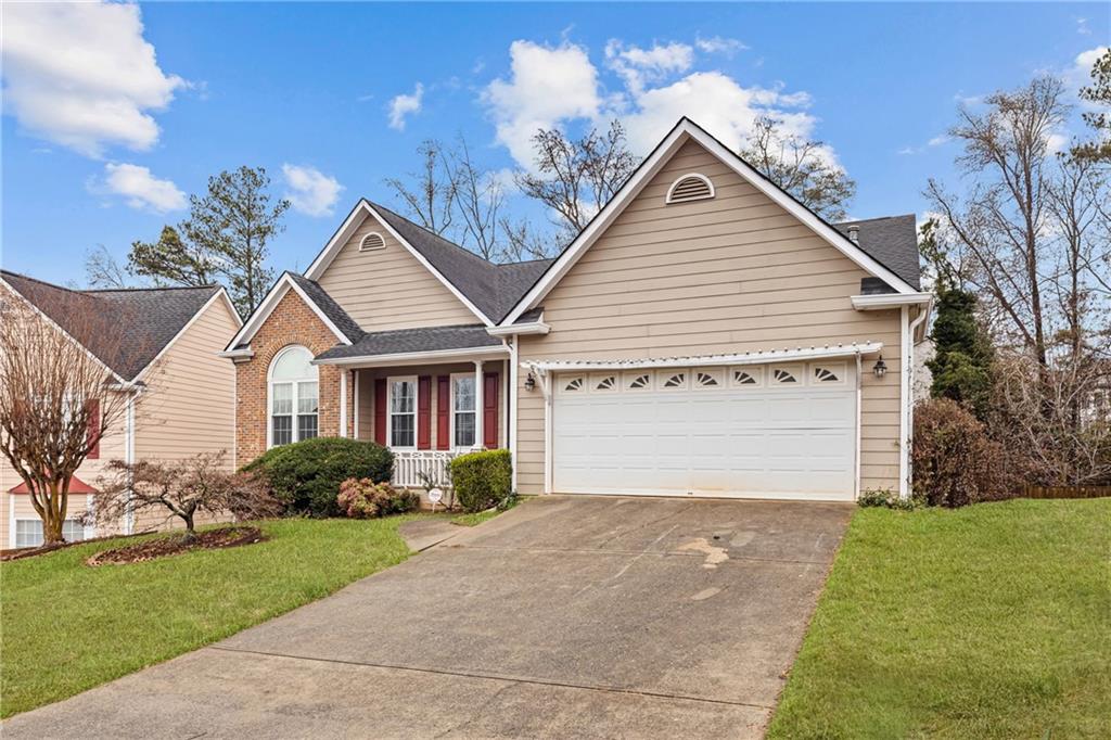 3360 Ennfield Lane Duluth, GA 30096 - Photo 32 of 38 a front view of a house with a garden and plants