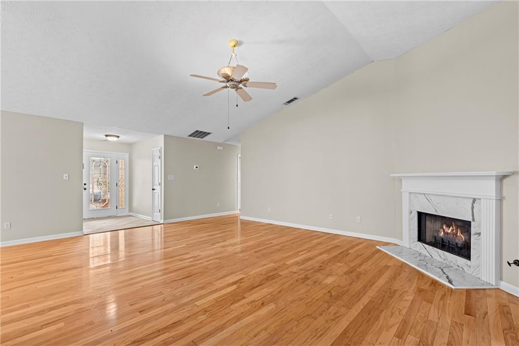 3360 Ennfield Lane Duluth, GA 30096 - Photo 5 of 38 a view of empty room with wooden floor and fireplace