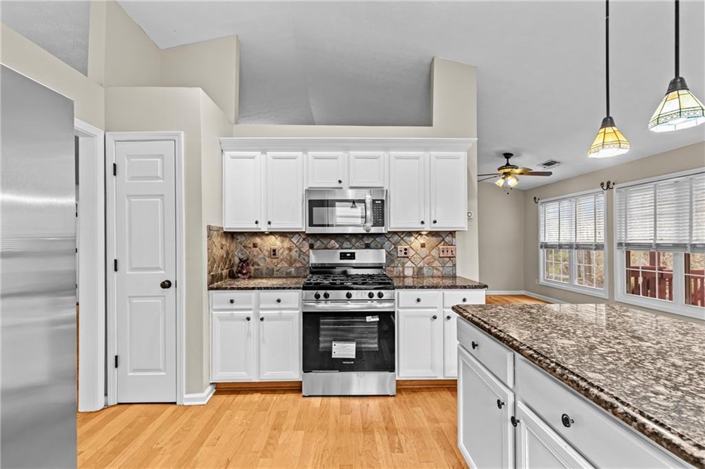 3360 Ennfield Lane Duluth, GA 30096 - Photo 9 of 38 a kitchen with stainless steel appliances granite countertop a stove and a sink