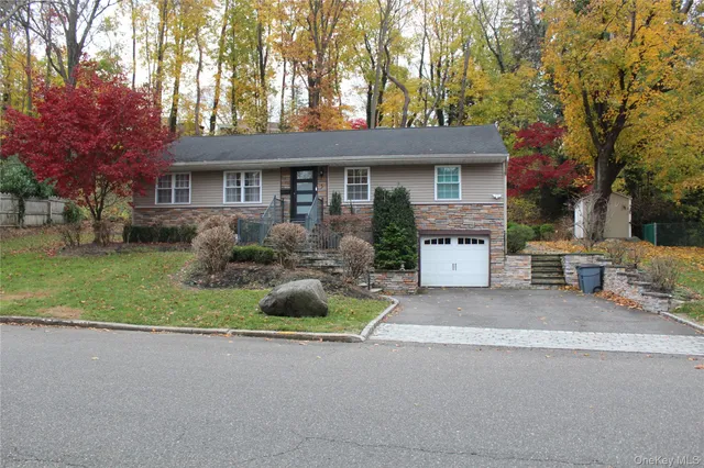 a front view of a house with a garden and plants