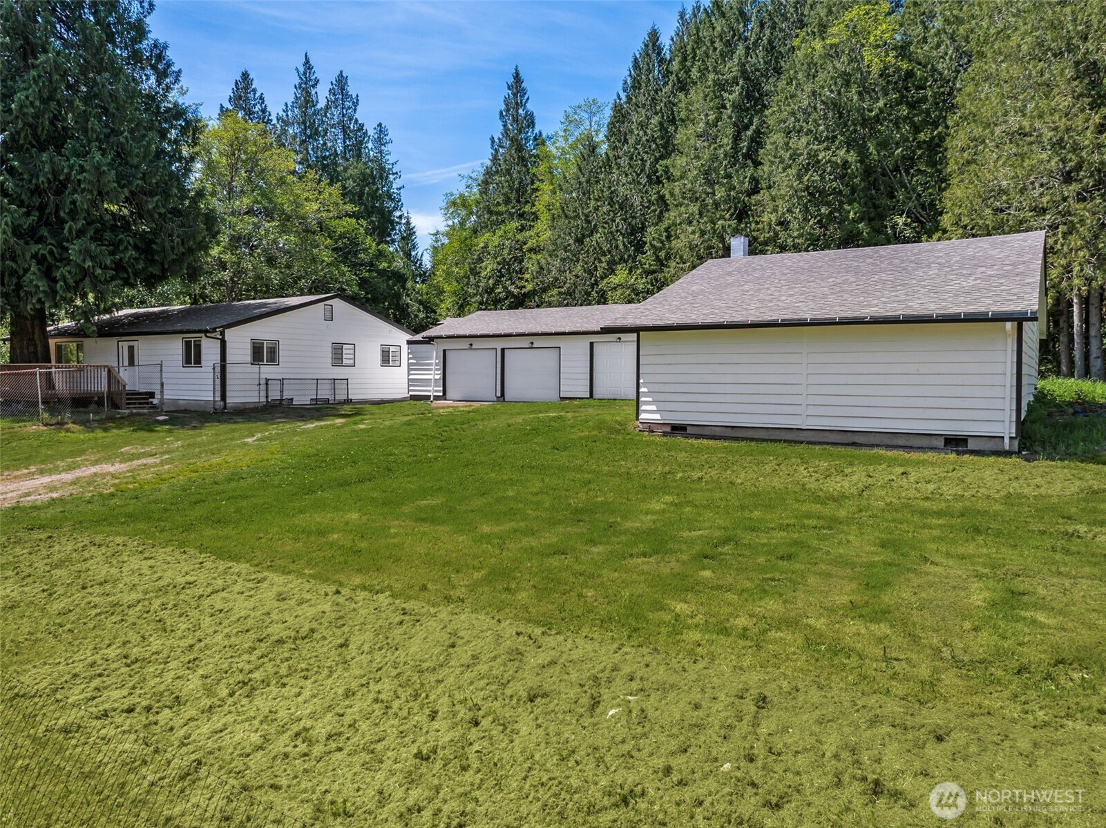 a view of a house with a yard and trees