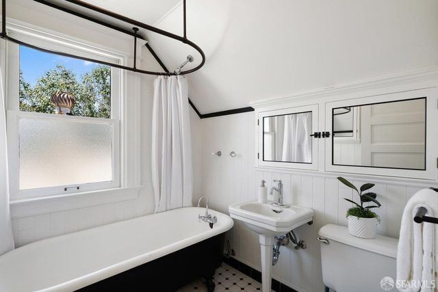 a bathroom with a sink a toilet and a mirror