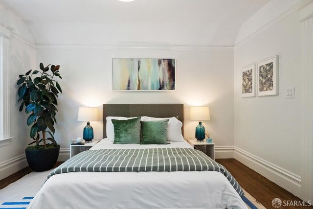 a bedroom with a bed and a potted plant