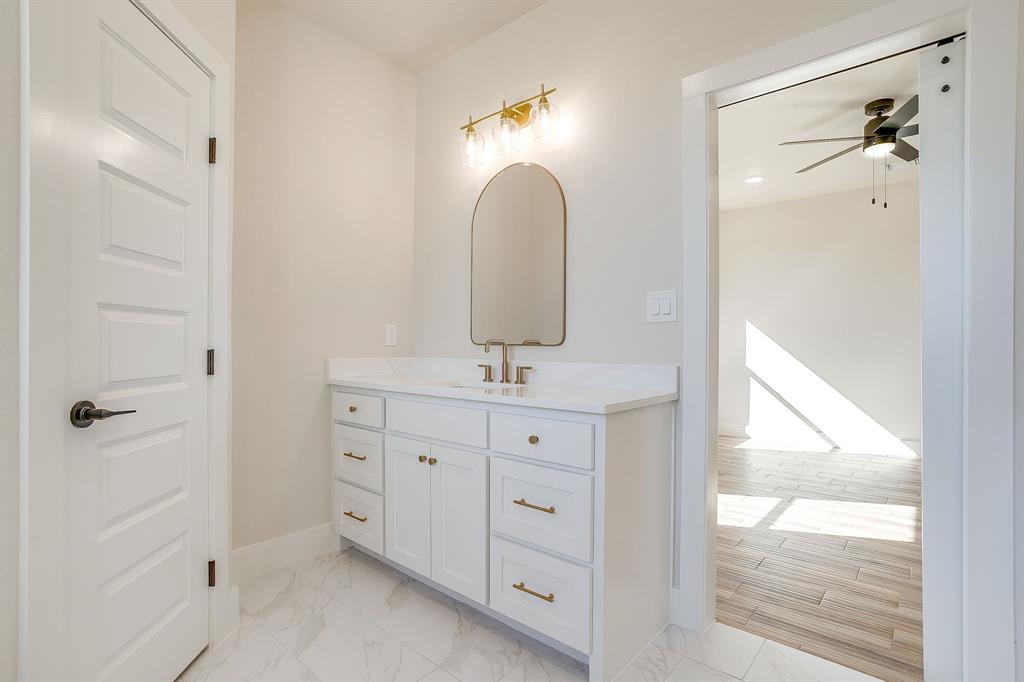 217 Kilkenny Road Poolville, TX 76487 - Photo 23 of 40 a bathroom with a double vanity sink and a mirror