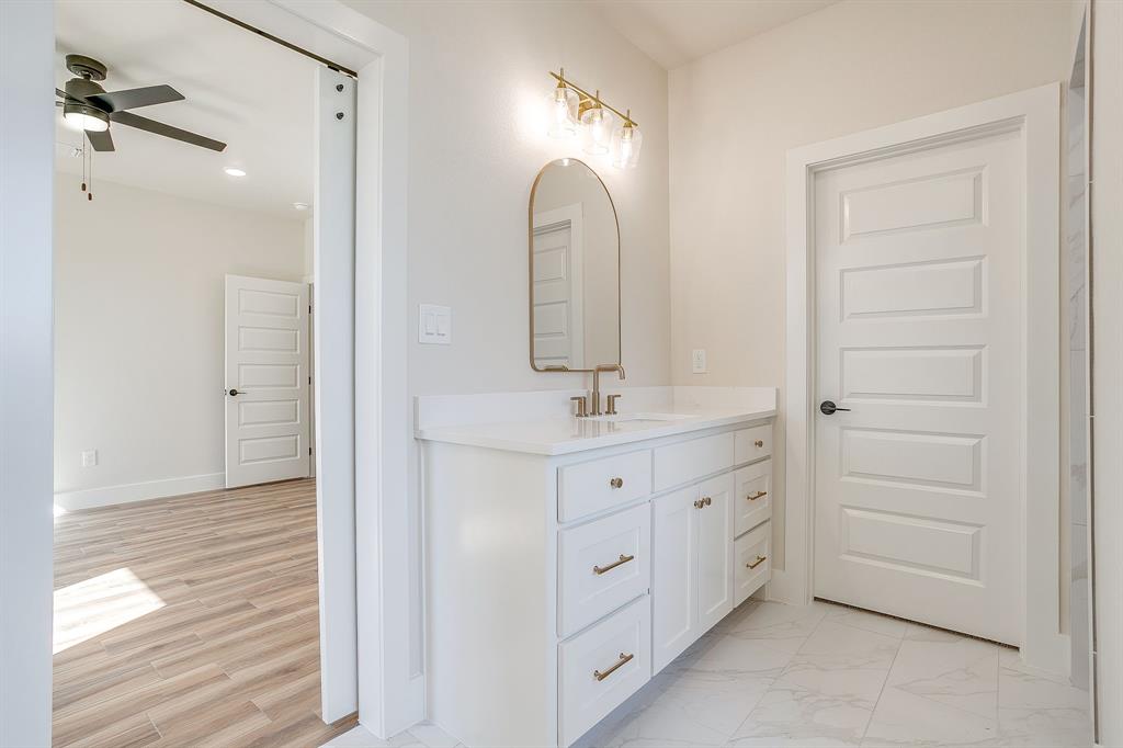 217 Kilkenny Road Poolville, TX 76487 - Photo 24 of 40 a bathroom with a double vanity sink mirror and