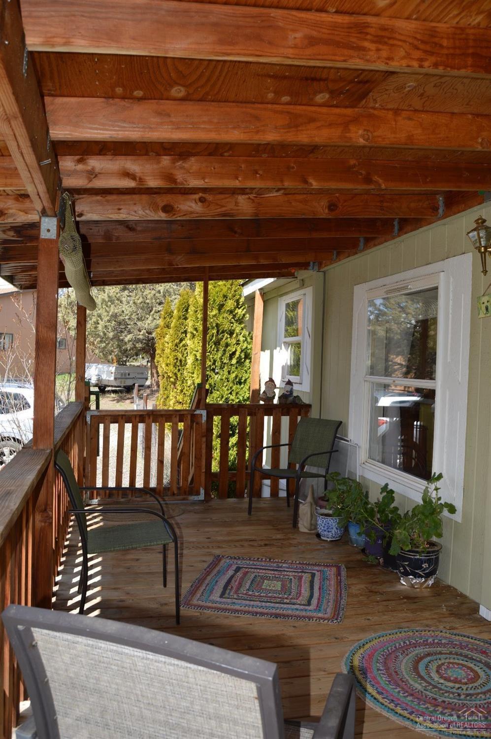 8280 Southwest Crater Loop Road Terrebonne, OR 97760 - Photo 14 of 25 The covered front deck gives you ample s