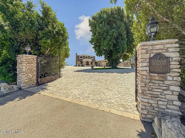 a brick building with a large tree