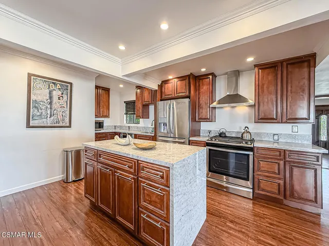 a kitchen with a sink cabinets and stainless steel appliances