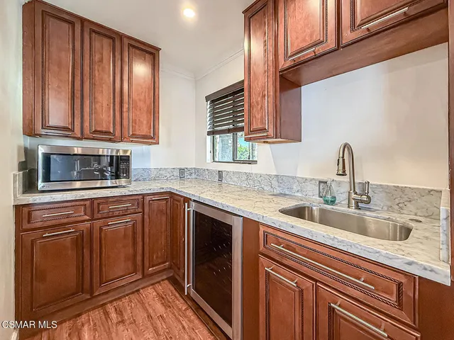 a kitchen with a sink and a refrigerator