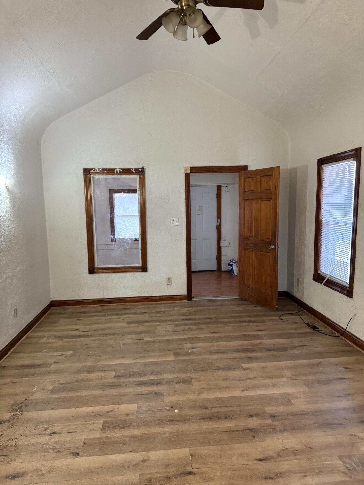 346 Richard Gordon Hatcher Boulevard Gary, IN 46404 - Photo 4 of 14 wooden floor in an empty room with a window