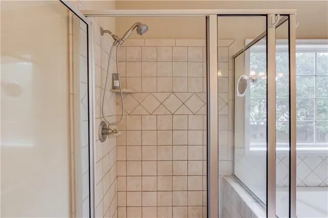 a bathroom with a glass shower door