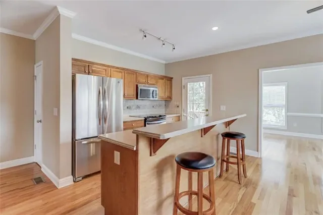 a kitchen with stainless steel appliances a refrigerator and a stove top oven