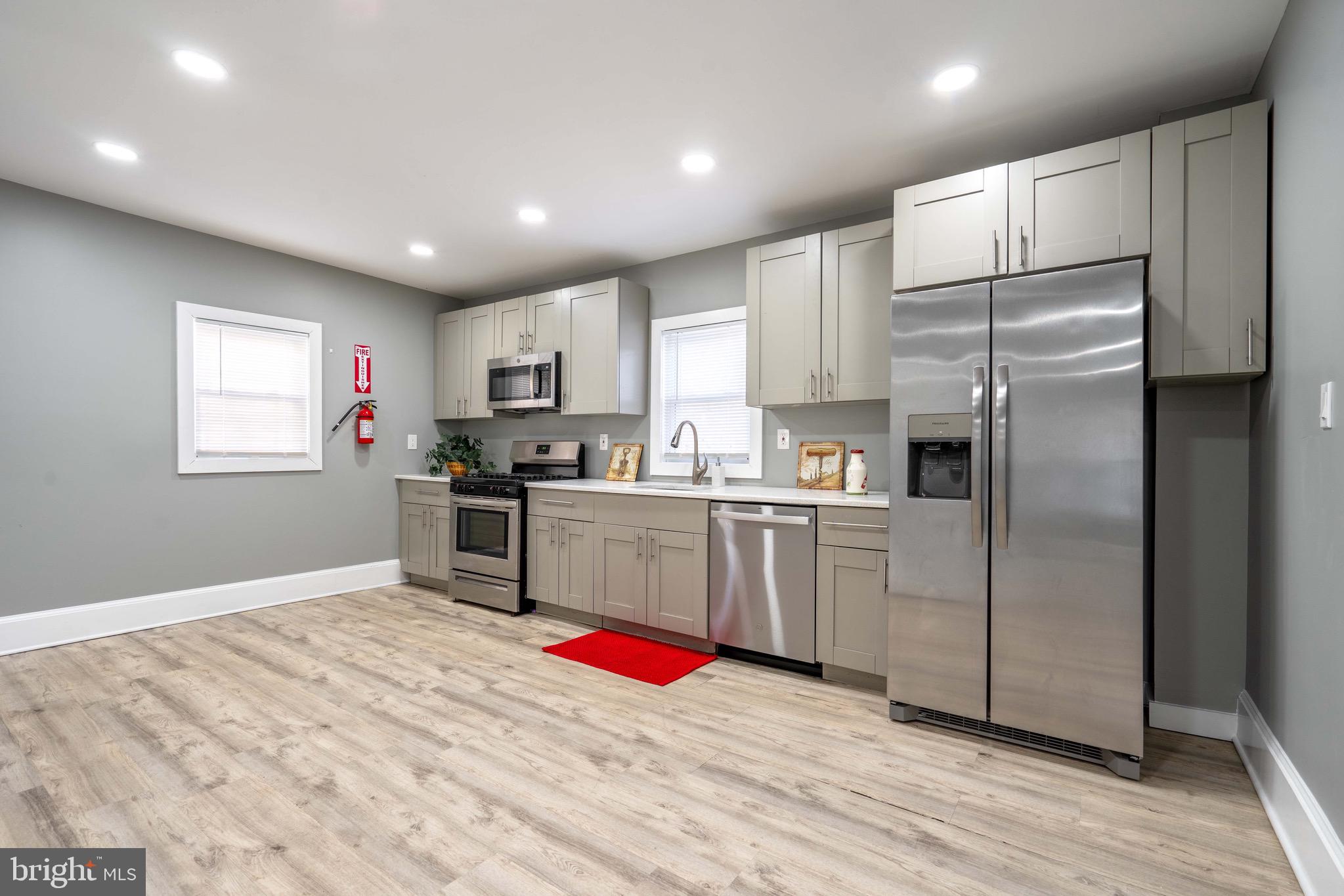 2172 Atco Avenue Atco, NJ 08004 - Photo 13 of 35 a kitchen with granite countertop a refrigerator and wooden cabinets