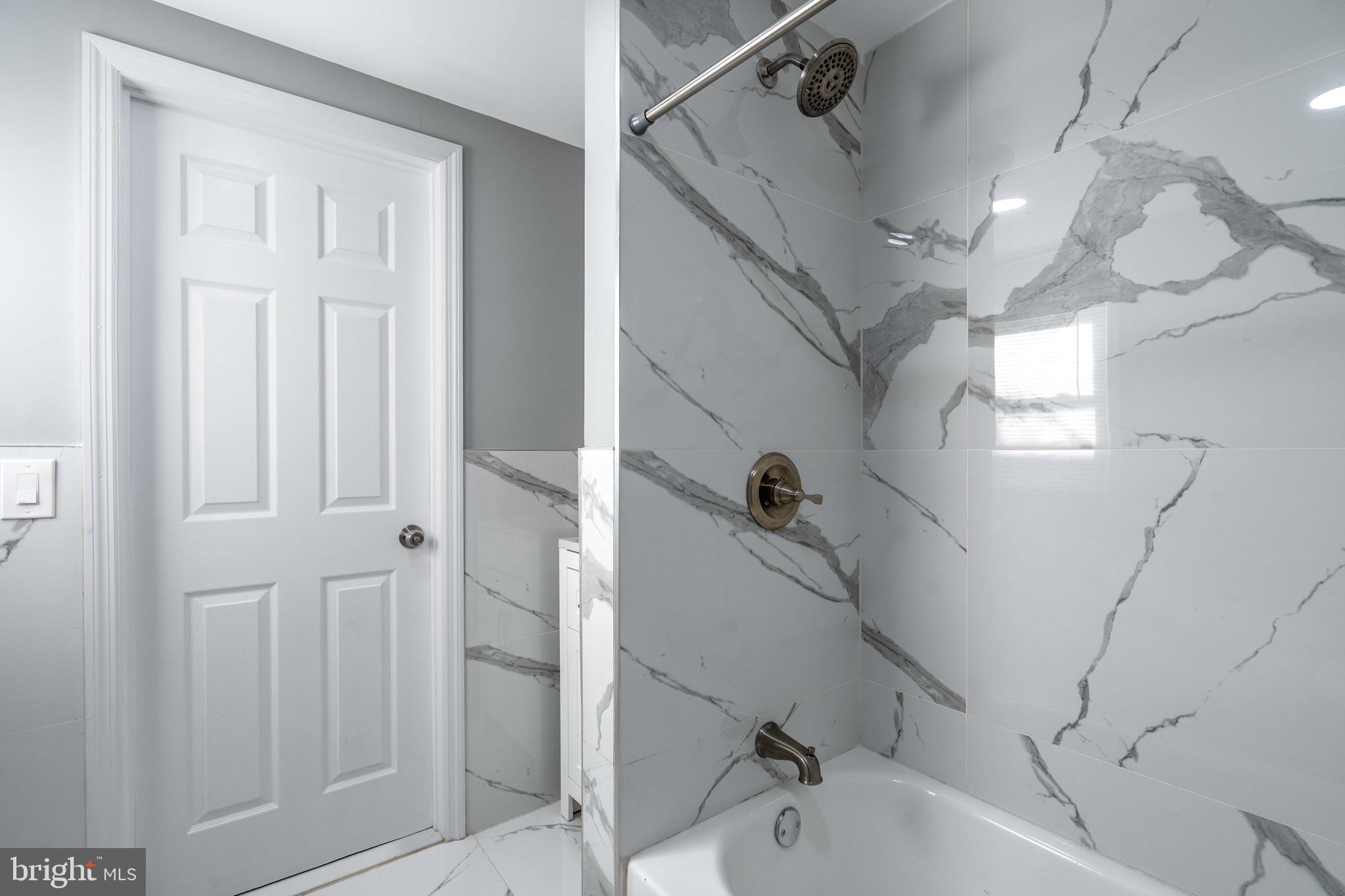 2172 Atco Avenue Atco, NJ 08004 - Photo 22 of 35 a bathroom with a bathtub and a shower