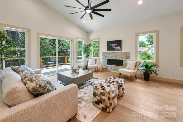 a living room with furniture fireplace and a large window