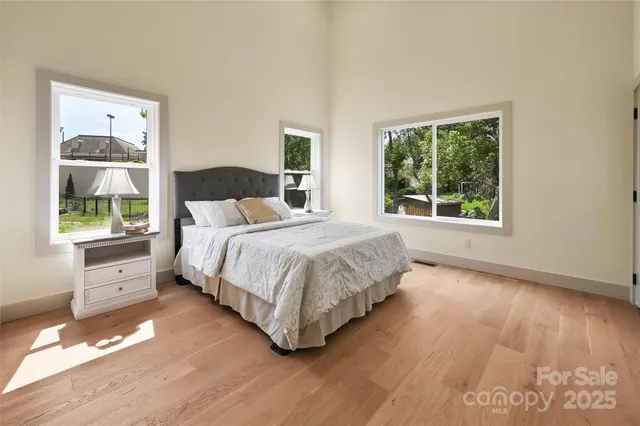 a bedroom with a bed and a large window