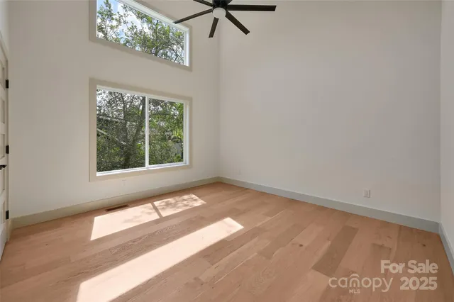 a view of a bedroom with a bed and a window