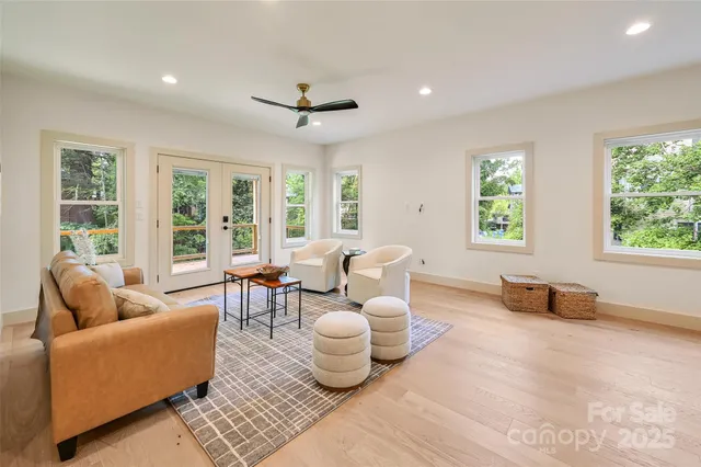 a view of a room with furniture and wooden floor