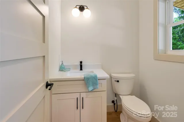 a white toilet sitting next to a bathroom sink