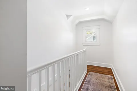a workspace with furniture hardwood floor and ceiling fan