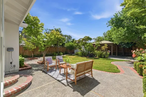 a view of a backyard with sitting area