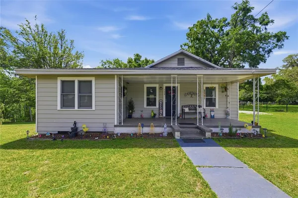a front view of a house with a garden and porch