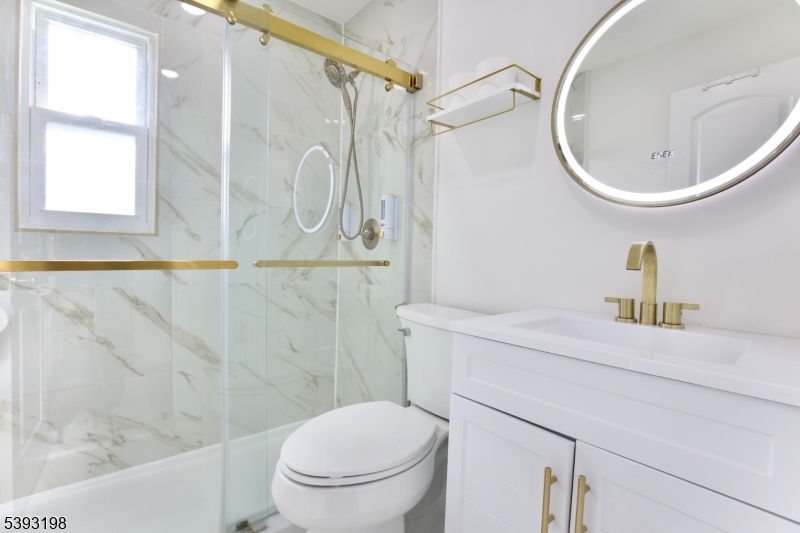 327 Roosevelt Lane Kenilworth, NJ 07033 - Photo 11 of 15 a bathroom with a sink a toilet and a mirror