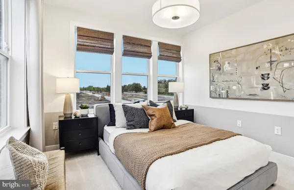 a bedroom with a bed and a painting on the wall