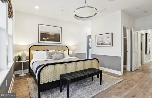a kitchen that has a lot of cabinets in it and wooden floors